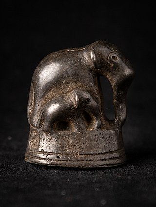 Bronze opium weight from Burma with elephant and calf on round base, three-quarter view