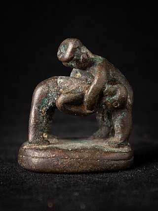 Bronze opium weight from Burma (Myanmar) with two intertwined figures, three-quarter view