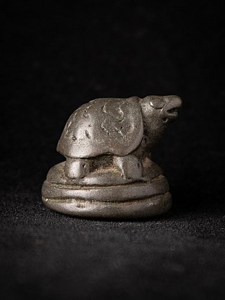 Bronze opium weight from Myanmar, animal form in right side profile on round base
