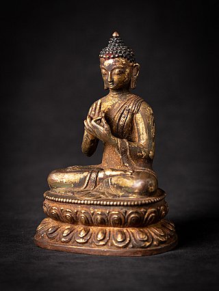 Nepali bronze Buddha statue seated in dharmachakra mudra, three-quarter right view