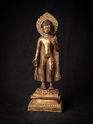 Buddha statue in bronze from Nepal, full-front view on stepped base with halo