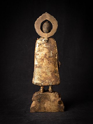 Bronze Nepal Buddha statue, rear view with worn surface and halo backplate