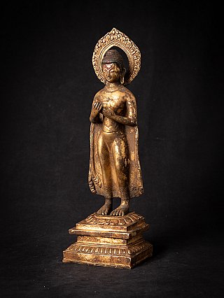 Bronze Buddha statue from Nepal with halo and hands at chest, three-quarter view