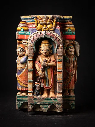 Indian wooden temple fragment with arched niche and three painted figures, full front view