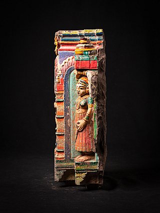 Side view of the right attendant figure on an Indian wooden temple fragment with polychrome paint