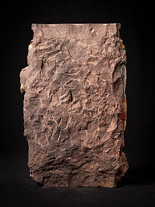 Rear view of the wooden temple fragment showing the rough uncarved back