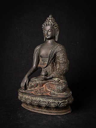 Indian bronze Buddha statue in three-quarter view, holding an alms bowl in the left hand