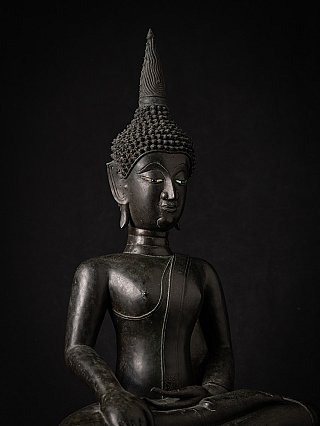 Head and torso detail of the bronze Buddha statue from Laos, three-quarter view
