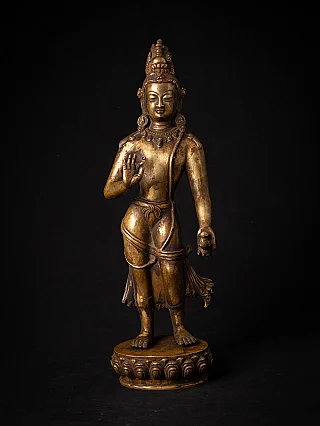 Nepali bronze Lokeshwor statue standing on a lotus base, right hand raised in vitarka mudra