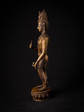 Nepali bronze Lokeshwor statue in side profile, standing on a round lotus base