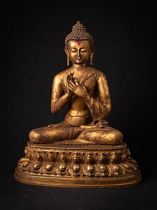 Buddha statue from Nepal in bronze, seated in dharmachakra mudra on a lotus base, full front