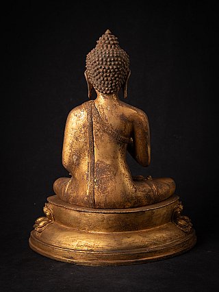Seated bronze Buddha statue from Nepal, rear view with robe draped over the shoulder