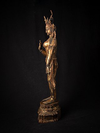 Green Tara statue in Nepali bronze, left side profile showing the raised hand in Vitarka mudra