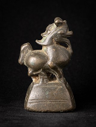 Bronze opium weight from Burma, animal figure in side view with tail to the left