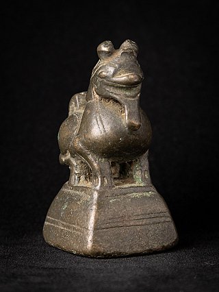 Old bronze opium weight from Myanmar, three-quarter view showing head and base