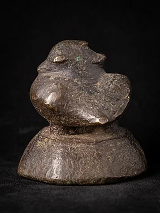 Antique bronze opium weight from Burma (Myanmar), three-quarter view with dark patina