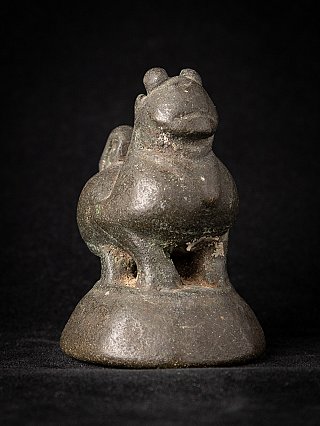 Antique bronze opium weight, three-quarter front view on a domed base