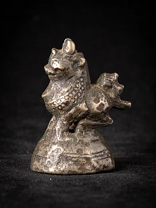 Antique Burmese bronze opium weight with animal figure on base, three-quarter left view