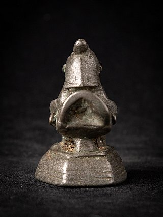 Antique bronze opium weight, rear view showing the tail opening and stepped base