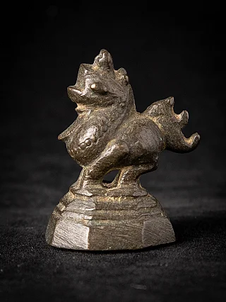 Burmese bronze opium weight, animal-form figure on stepped base in three-quarter view