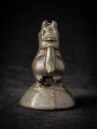 Antique Burmese bronze opium weight, front view showing the snout and tail