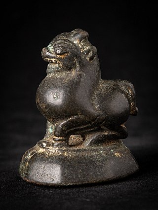 Antique bronze opium weight from Burma, animal-form figure on base in left three-quarter view