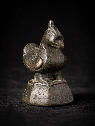 Burmese bronze opium weight, three-quarter view highlighting the curled tail