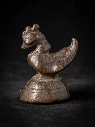 Antique Burmese bronze opium weight, animal-shaped form on round base in three-quarter view