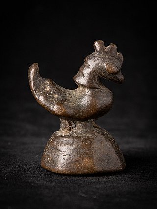 Antique bronze opium weight from Myanmar, side profile with curled tail on base