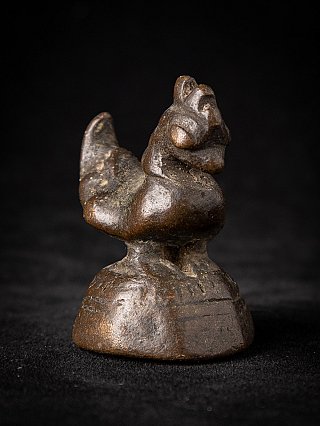 Burmese bronze opium weight, three-quarter view highlighting head and chest on round foot
