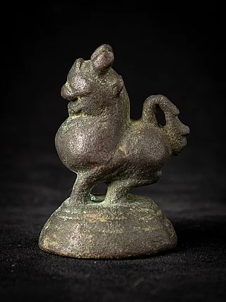 Bronze opium weight from Burma (Myanmar), animal figure on round base in left side view