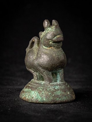 Bronze opium weight from Myanmar, three-quarter view showing green patina on the round base
