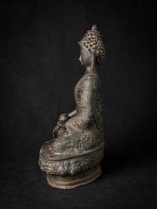 Indian bronze Buddha statue seated on round base, left side profile