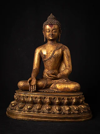 Nepali bronze Buddha statue seated on lotus base, full front view with varada mudra