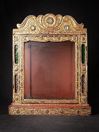 Antique wooden Burmese temple shrine with gilded front frame and glass panel, front view