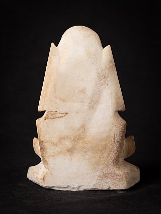 Rear view of the Burmese marble monk statue showing the back slab and surface staining