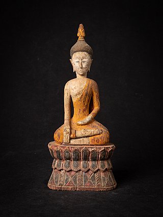 Thai wooden Buddha statue seated in bhumisparsha mudra, full front view on carved base