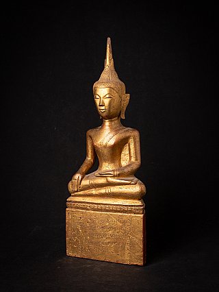 Buddha statue in Thai Lanna style, wooden, three-quarter view with inscribed base