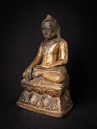 Wooden Buddha statue from Burma (Myanmar), seated on lotus base, three-quarter left view