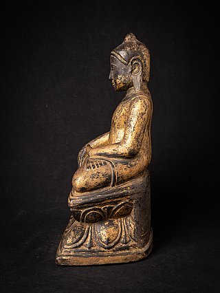 Burmese wooden Buddha statue seated in bhumisparsha mudra, left side profile