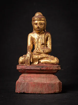 Burmese wooden Buddha statue on red base, full-front view
