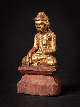 Wooden Buddha statue from Burma (Myanmar), three-quarter view with red base