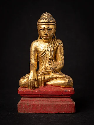 Burmese wooden Buddha statue, seated in bhumisparsha mudra on red base, full front view