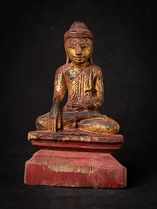 Antique wooden Burmese Buddha statue seated in bhumisparsha mudra, full front view