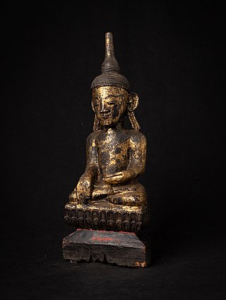 Wooden Burmese Buddha statue with worn gilding, three-quarter left view
