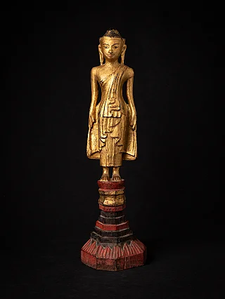 Antique wooden standing Buddha statue
