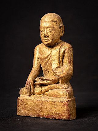 Burmese wooden monk statue seated, three-quarter right view