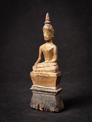 Thai wooden Buddha statue on tall base, three-quarter left view