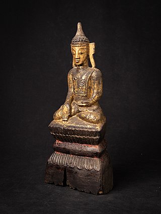 Wooden Buddha statue from Burma (Myanmar) with worn gilding, three-quarter left view