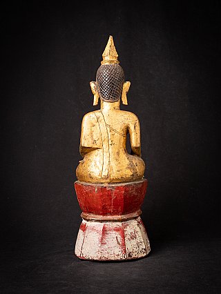 Seated wooden Buddha statue from Laos, rear view showing hair texture and pointed ushnisha